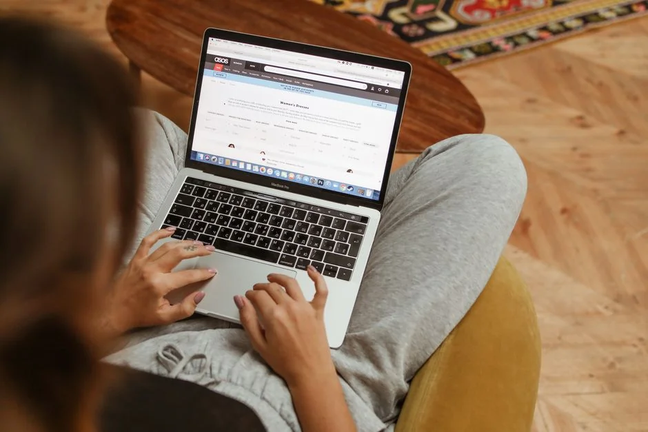 heros-img A person using a laptop to browse stock photo websites. Freelancing work in a cozy setting.